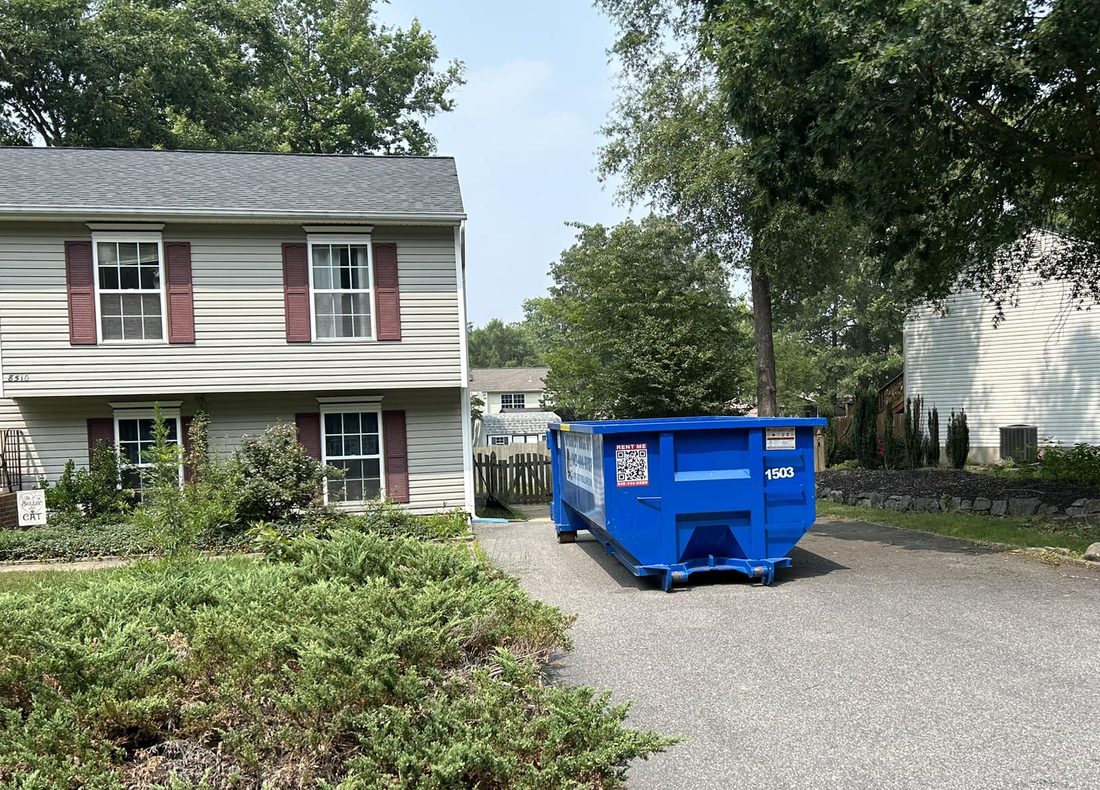 Integrity Roll Off dumpster set at the top of a residential driveway